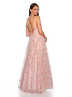 This dress features a pleated bodice with an illusion plunge, a cross strap open back, and a full tulle skirt with a side slit and asymmetrical ruffle detail. This dress is romantic and whimsical and could be a stunning choice for your next prom or formal event.  DJ 11590