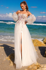 This dress features an off-the-shoulder neckline with a floral lace applique bodice, and a wispy tulle skirt, while the detachable puffy sleeves offer a playful nod to modern Renaissance. This dress is a fun and unique choice for your next prom or formal event.   ACE SU070