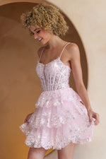 This cocktail dress features an illusion-plunging neckline with a sheer corset bodice and lace embellishments, spaghetti straps, and a lace-up back. The skirt has tiered layers with lace on the hem. This dress is feminine and unique and could be perfect for your next homecoming or formal event.  ACE BZ9031S