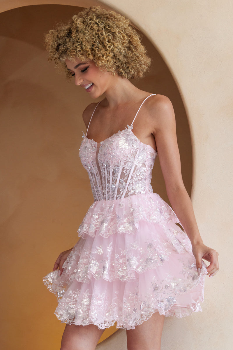 This cocktail dress features an illusion-plunging neckline with a sheer corset bodice and lace embellishments, spaghetti straps, and a lace-up back. The skirt has tiered layers with lace on the hem. This dress is feminine and unique and could be perfect for your next homecoming or formal event.  ACE BZ9031S