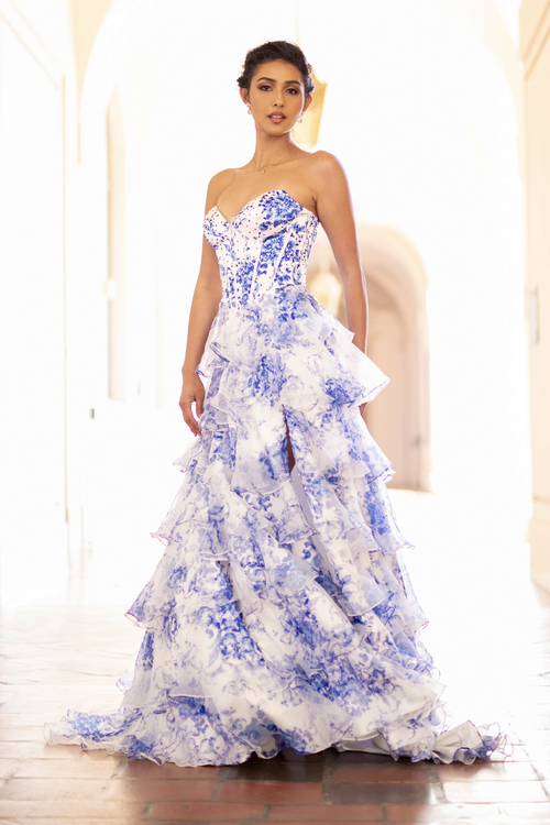 This gown features a strapless sweetheart neckline with corset boning in the bodice and a lace-up back. The skirt features tiered layers with a slit all in a unique print fabric. Style this dress to make it your own at your next prom or formal event.

ACE 2060