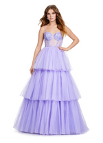 This tiered tulle ball gown features a sheer beaded bustier complete with spaghetti straps and an illusion plunge neckline. The tiered ruffle skirt completes this modern look. Choose this stunning gown for your next prom or formal event.   Ashley Lauren 11462