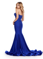 This dress features a strapless neckline, fitted jersey fabric, and a fit and flare silhouette. This gown has an illusion v-neckline with a fully beaded bodice with corset boning and press on stones that are scattered across the entire dress. This is a stunning choice for your next prom or formal event.  Ashley Lauren 11560