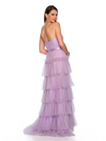 This dress features a fitted bodice with a strapless neckline, a tiered skirt and tulle fabric. This dress is romantic and ideal for prom or your next formal event!  DJ 11579
