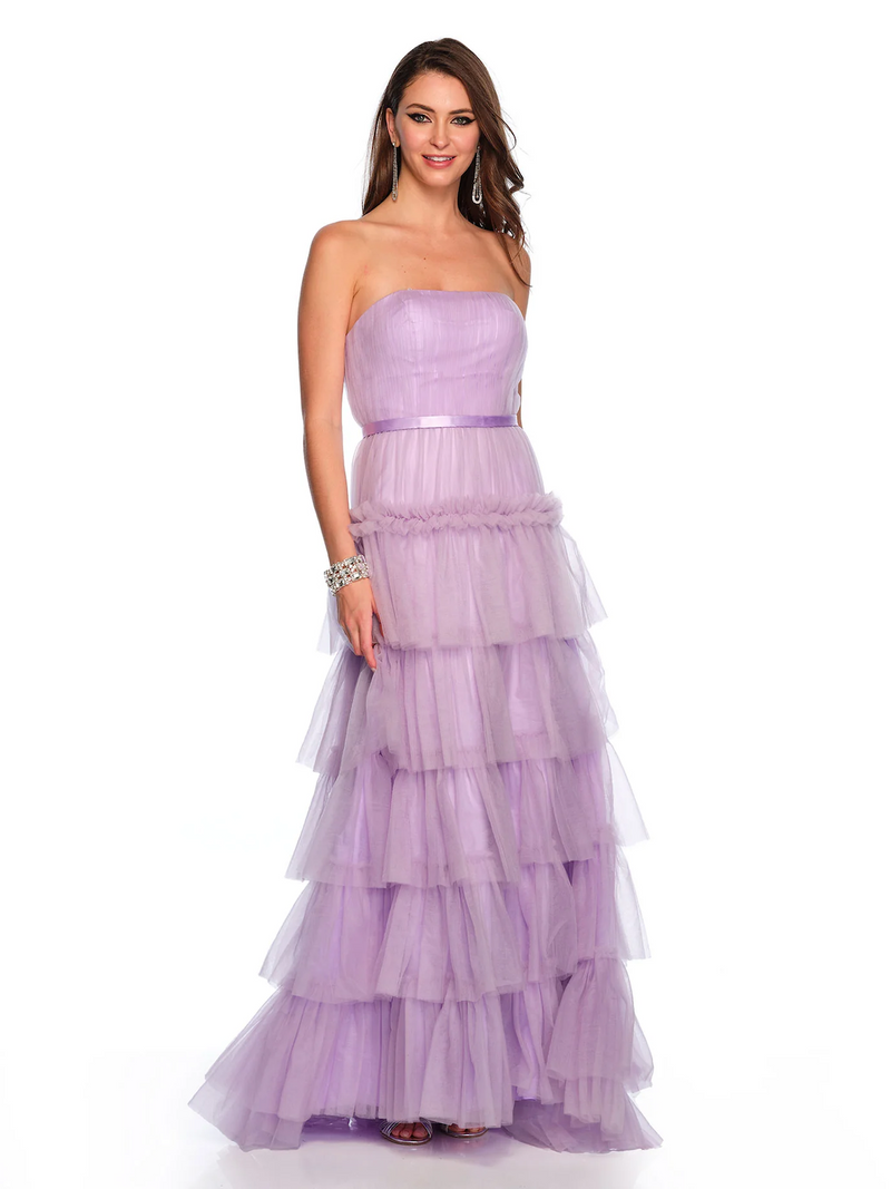 This dress features a fitted bodice with a strapless neckline, a tiered skirt and tulle fabric. This dress is romantic and ideal for prom or your next formal event!  DJ 11579