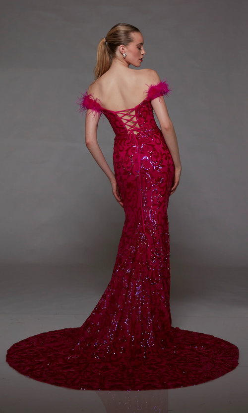 This dress features an off-the-shoulder neckline with feather trim on the shoulders, a sequin fabric with a paisley design, a lace-up back and a train. This dress is one-of-a-kind and ideal for your next prom, pageant, or formal event.  Alyce 1789