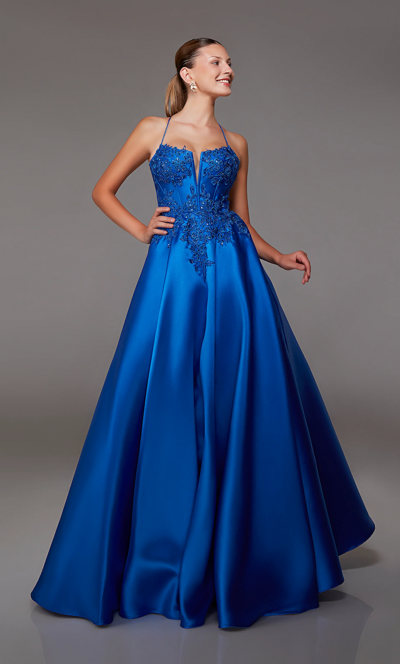 This dress features a lace applique bodice with corset boning and a deep v-neckline. This gown has spaghetti straps and an open lace-up back with an A-line silhouette. Choose this romantic dress for your next prom or formal event.  Alyce 1817