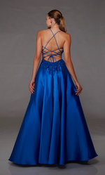 This dress features a lace applique bodice with corset boning and a deep v-neckline. This gown has spaghetti straps and an open lace-up back with an A-line silhouette. Choose this romantic dress for your next prom or formal event.  Alyce 1817