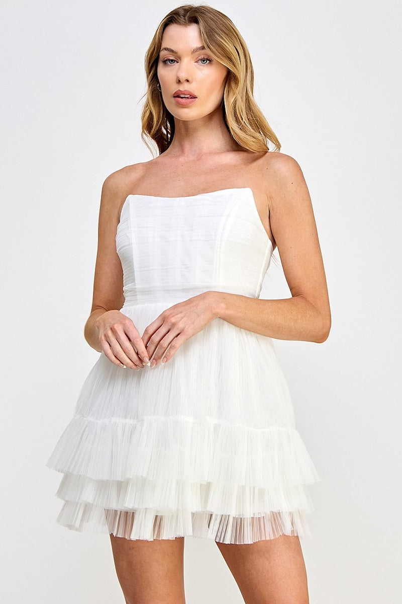 This cocktail dress features a strapless neckline with an A-line silhouette and a layered tulle-tiered skirt. Style this dress to make it your own at your next homecoming or formal event.  VT VID10761