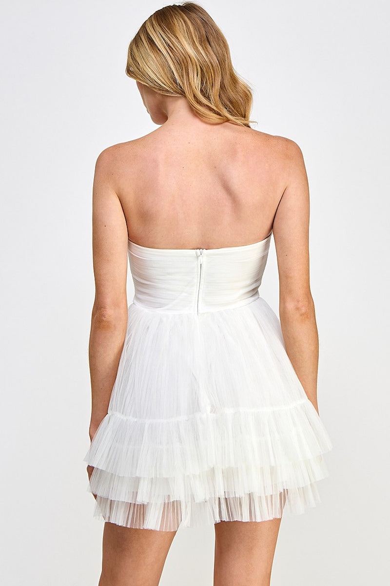 This cocktail dress features a strapless neckline with an A-line silhouette and a layered tulle-tiered skirt. Style this dress to make it your own at your next homecoming or formal event.  VT VID10761