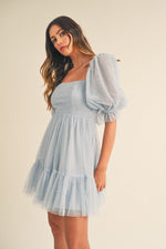 This dress features pearl stud swiss dot mesh with a short puff ruffle sleeve a babydoll silhouette with an open-back self-tie detail. This playful dress is an excellent choice for your next homecoming, sweethearts dance or formal event!  MAE-MD4369