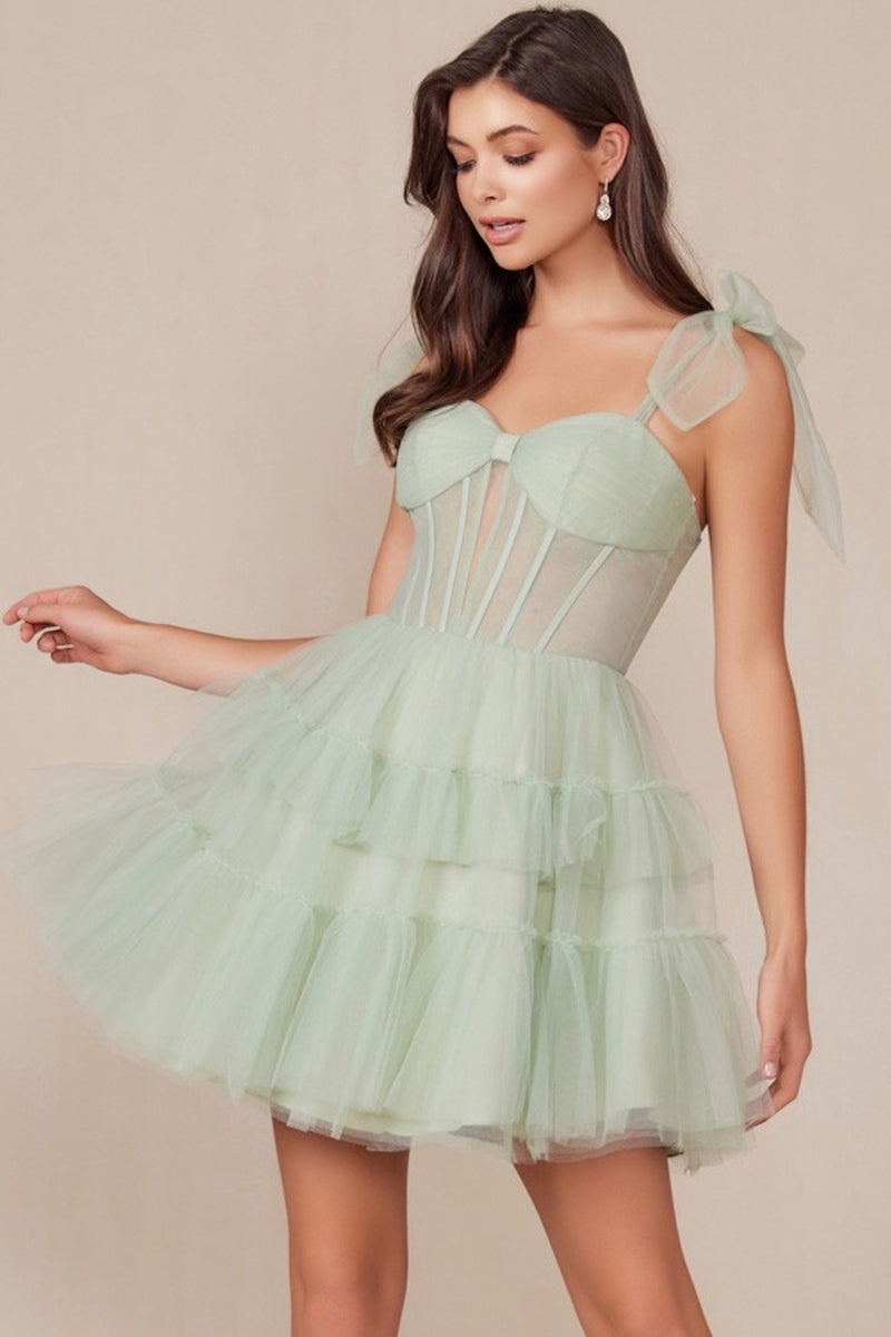 This cocktail dress features tulle fabric with a tiered ruffle skirt, tie shoulder straps, with a sheer corset bodice. This dress is playful and could be just the vibe for your next homecoming or formal event.  BFX Y858