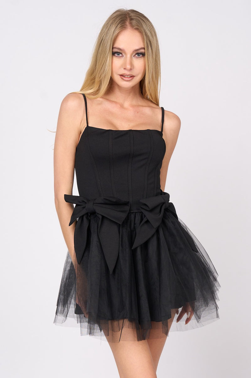 This cocktail dress features a straight across neckline with adjustable spaghetti straps, with 2 dramatic bows on the hips and a tulle skirt. This dress is playful and unique and could be just the vibe for your next homecoming or formal event.&nbsp;  PVY PD77204