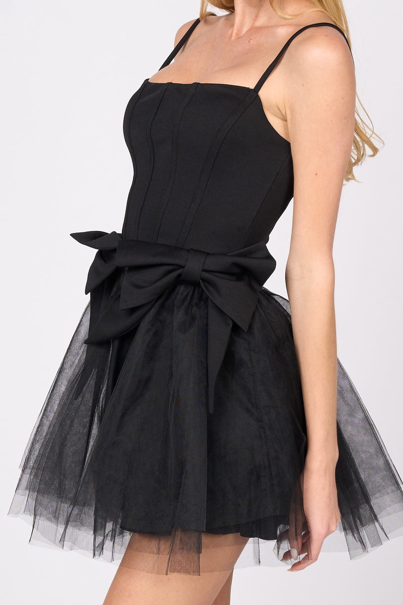This cocktail dress features a straight across neckline with adjustable spaghetti straps, with 2 dramatic bows on the hips and a tulle skirt. This dress is playful and unique and could be just the vibe for your next homecoming or formal event.&nbsp;  PVY PD77204