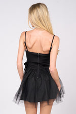 This cocktail dress features a straight across neckline with adjustable spaghetti straps, with 2 dramatic bows on the hips and a tulle skirt. This dress is playful and unique and could be just the vibe for your next homecoming or formal event.&nbsp;  PVY PD77204