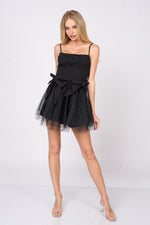 This cocktail dress features a straight across neckline with adjustable spaghetti straps, with 2 dramatic bows on the hips and a tulle skirt. This dress is playful and unique and could be just the vibe for your next homecoming or formal event.&nbsp;  PVY PD77204