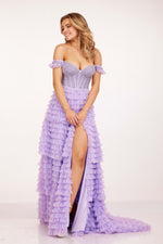 This dress features a sweetheart neckline with off-the-shoulder straps, a bodice embellished with pearls and crystal beading, and corset boning. The skirt features tiered ruffle fabric and a slit with a lace-up back. This dress is unique and playful and could be your dream dress at your next prom or formal event.   CAC 2224