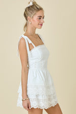 This cocktail dress features a straight across neckline with straps with ties at the shoulder, double tiered layered skirt with lace trim. This dress could be just the vibe for your next homecoming or formal event.

DM A3412