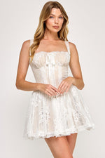This lace corset mini dress features a flared skirt and spaghetti straps, a square neckline with lace trim and a corset lace-up back. This dress has a boho vibe and could be ideal for your next homecoming or formal event!

TVS VID50697-8