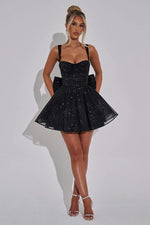 This cocktail dress features a shimmering tulle fabric with thin straps, a ruched bodice, a dramatic bow in the back, and an A-line silhouette. This dress is romantic and could be ideal for your next homecoming or formal event.&nbsp;

HIC HGMI56001D