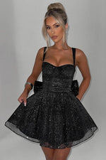 This cocktail dress features a shimmering tulle fabric with thin straps, a ruched bodice, a dramatic bow in the back, and an A-line silhouette. This dress is romantic and could be ideal for your next homecoming or formal event.&nbsp;

HIC HGMI56001D