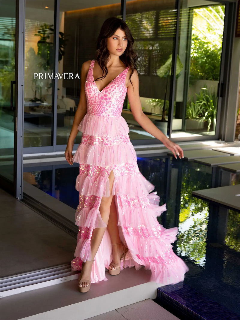 This dress features a v-neckline and a low back, a ruffled tiered skirt, and a slit. This dress is an A-line silhouette and is unique and feminine. Choose this one-of-a-kind dress for your next prom or formal event.   PV 4142