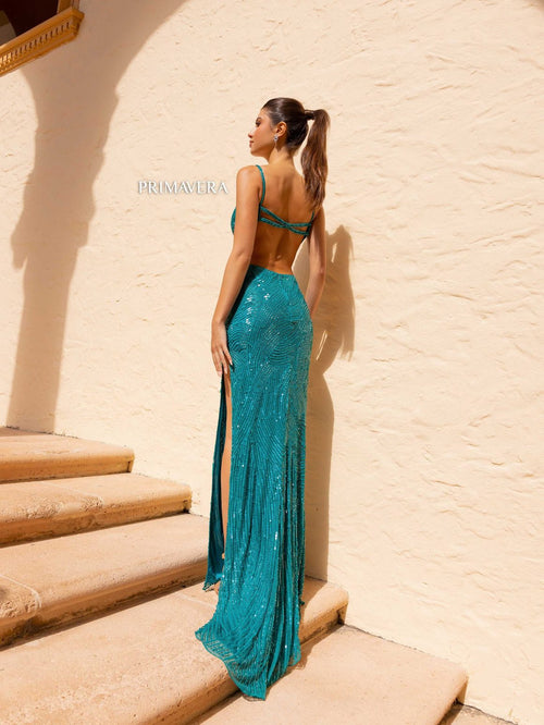 This dress features a deep v-neckline and open back with beaded closure straps and a fully sequined fabric and side slit. This dress is glamorous and ideal for your next prom or formal event.  PV 4159