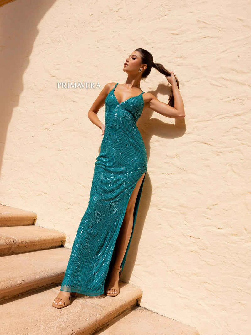This dress features a deep v-neckline and open back with beaded closure straps and a fully sequined fabric and side slit. This dress is glamorous and ideal for your next prom or formal event.  PV 4159