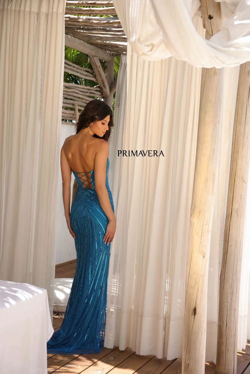 This dress features a strapless neckline with a lace-up back and a cutout detail in the bodice. The fabric is fully sequined and beaded with a fitted silhouette and a skirt slit. This is a unique choice for your next prom or formal event.

PV 4309