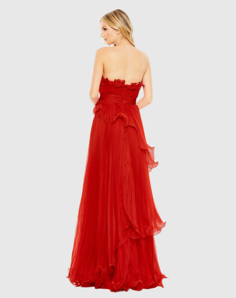Designed in solid chiffon, this dress focuses on luxe texture—pleats and structured ruffles. The strapless neckline pairs perfectly with a faux waist sash and a Grecian-inspired asymmetrical, tiered skirt. Stun at your next prom or formal event in this stunning gown.

Mac Duggal 49537