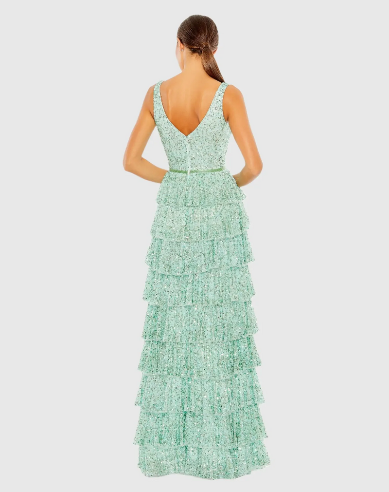 Crafted from sequin-embellished mesh, the gown is styled with a surplice bodice, sleeveless shoulders, and a tiered A-line skirt with just enough volume. A slim, beaded waistband offers a dazzling touch and unites fitted top and ruffled bottom. This dress could be ideal for your next prom or formal event.

Mac Duggal 5627