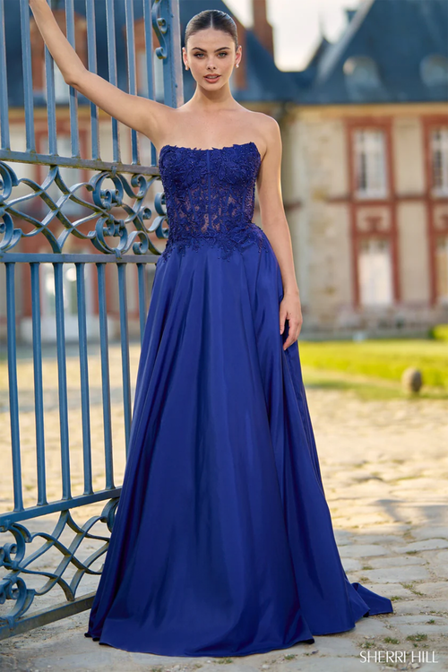 This dress features a strapless A-Line silhouette, with lace applique along the exposed corset bodice, and a slit in the skirt. Pair this dress with simple heels for your next prom or formal event.&nbsp;

Sherri Hill 56912