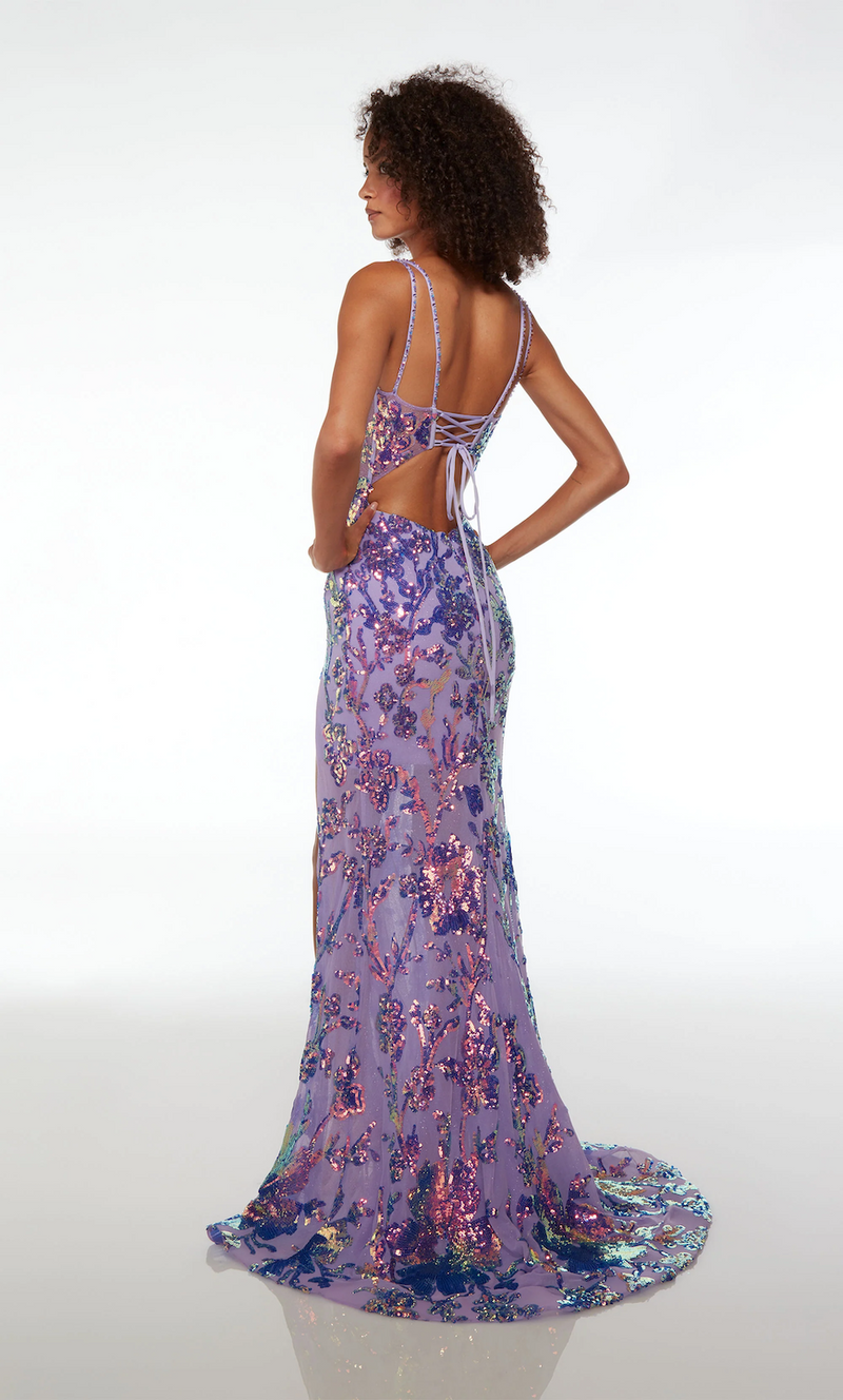 This dress features an illusion-plunging neckline with double spaghetti straps and an open back with a lace-up. The fabric is embellished with sequins throughout and designed in an intricate pattern. The silhouette is fitted with a skirt slit and a slight train. This gown is unique and playful and could be ideal for your next prom or formal event.  AY 61661