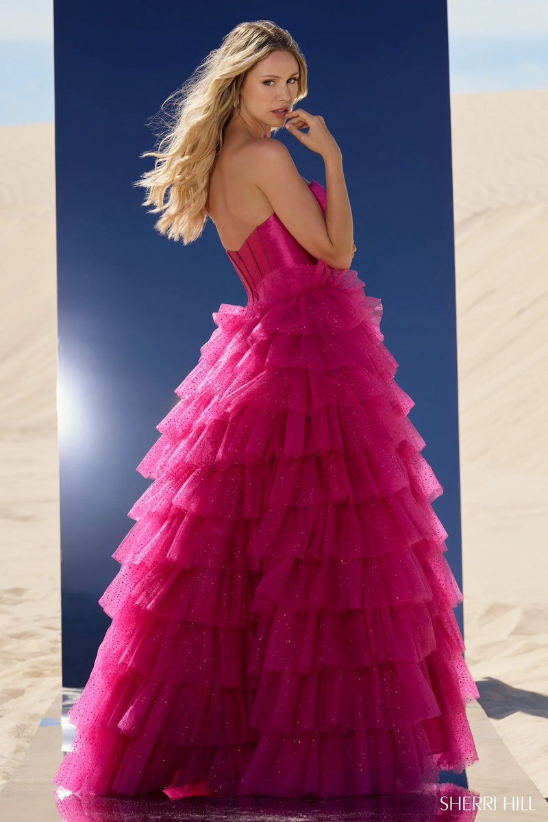 This ball gown features a strapless sweetheart neckline with a keyhole bodice, a tulle ruffle skirt and a high slit. This dress is unique and dramatic and could be just the vibe for your next prom or formal event.



Sherri Hill 56804