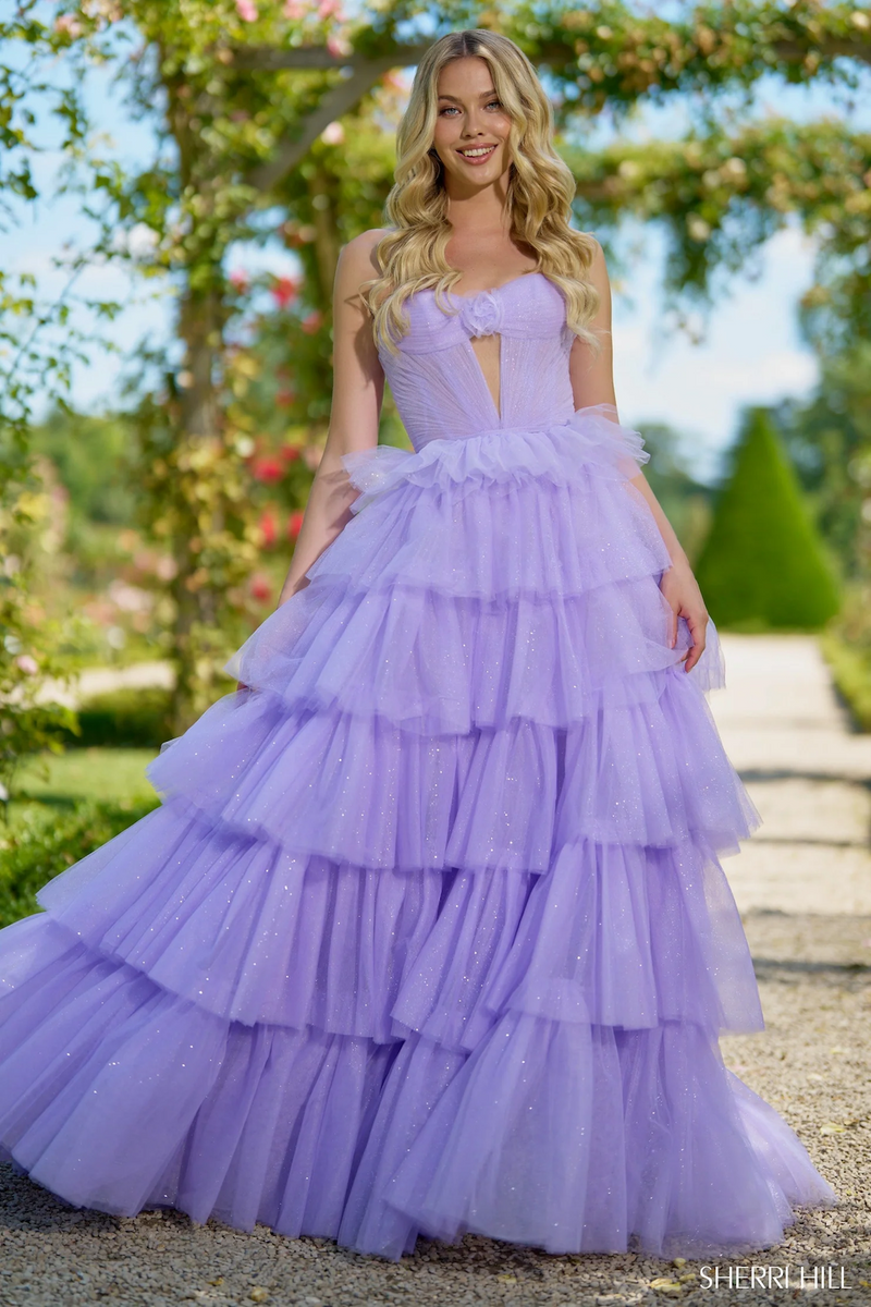 This dress features a strapless neckline with a keyhole, and rosette embellishment in the bodice. The sparkle tulle fabric with a ruffle skirt creates a fairytale vibe for this stunning gown.&nbsp;

Sherri Hill 56884