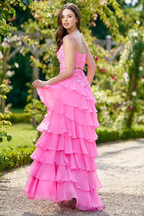 This Sherri Hill gown features leaf lace throughout the bodice, a cutout back, and chiffon ruffle slit skirt. Pair with some fun heels for the perfect prom look!&nbsp;

Sherri Hill 56961