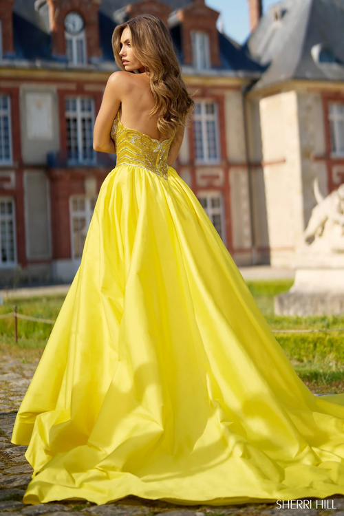 This ballgown features a strapless sweetheart neckline with a beaded bodice, and a voluminous taffeta skirt with a slit. This dress is elegant and could be perfect for your next pageant or formal event.

Sherri Hill 67015