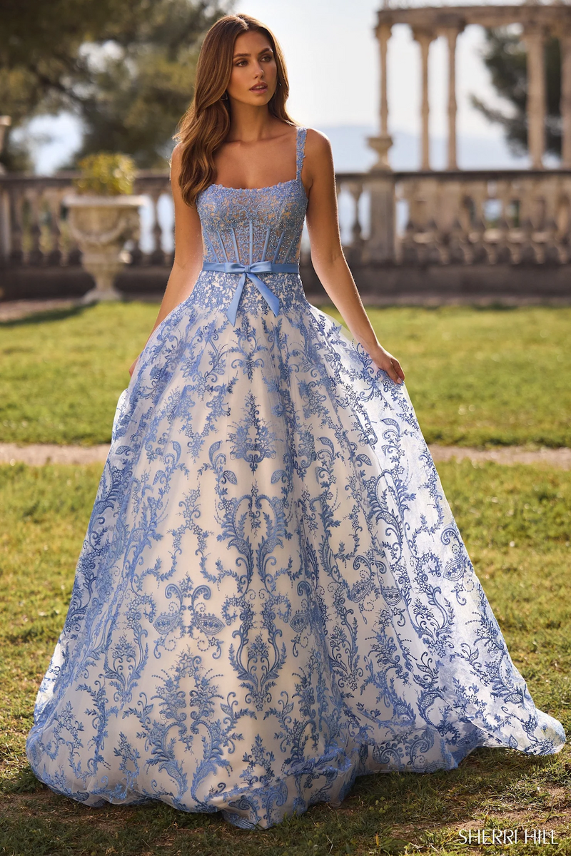 This dress features a floral embroidered bodice with corset boning, a voluminous skirt creating an A-line silhouette in this intricate ivory and blue fabric. Stun at your next prom or formal event in this gorgeous ballgown.

Sherri Hill 57058