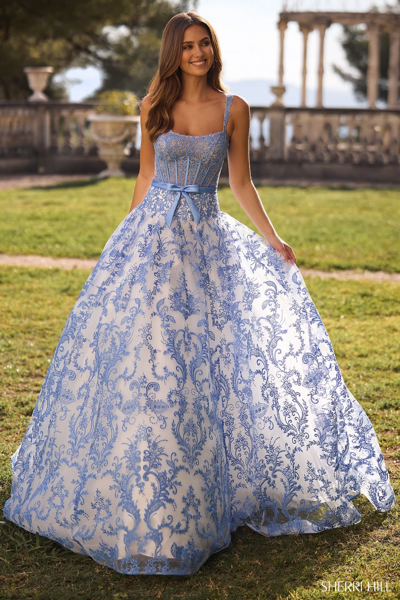 This dress features a floral embroidered bodice with corset boning, a voluminous skirt creating an A-line silhouette in this intricate ivory and blue fabric. Stun at your next prom or formal event in this gorgeous ballgown.

Sherri Hill 57058