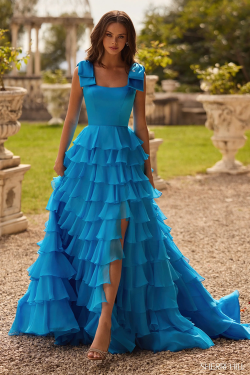 This dress features a satin fabric, an A-Line silhouette with bow straps and a chiffon ruffle skirt with a high slit. Make a statement at your next prom, pageant or formal event.

Sherri Hill 57215