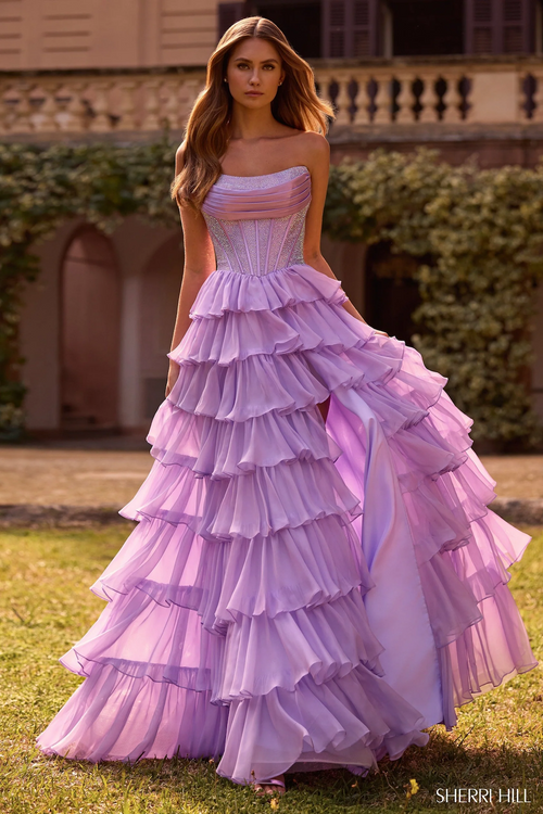 This strapless gown features hot fix stones, a corset bodice and a chiffon ruffle skirt with a slit. This dress is a stunning choice for your next prom or formal event.

Sherri Hill 57288