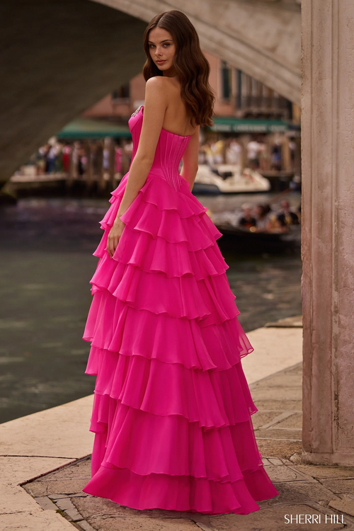 This strapless ballgown features a corset bodice, a chiffon ruffle skirt with a slit, and bead embellishments. Choose this stunning gown for your next prom, pageant or formal event.

Sherri Hill 57581