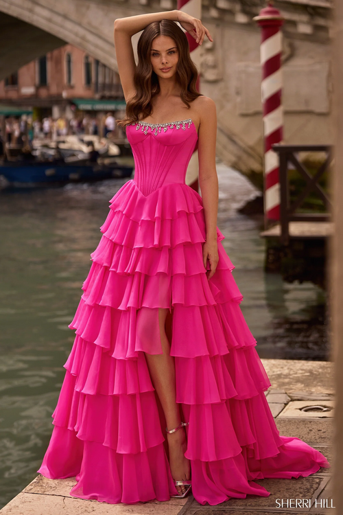 This strapless ballgown features a corset bodice, a chiffon ruffle skirt with a slit, and bead embellishments. Choose this stunning gown for your next prom, pageant or formal event.

Sherri Hill 57581