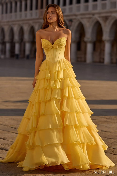 This strapless sweetheart ballgown features a silk corset bodice with a bow detail, a chiffon ruffle skirt, and a skirt slit. This dress is elegant and could be ideal for your next prom or formal event.

Sherri Hill 57586