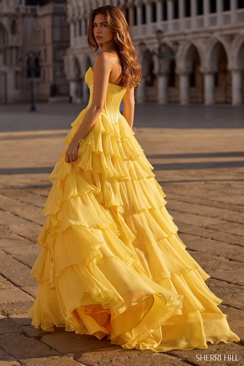This strapless sweetheart ballgown features a silk corset bodice with a bow detail, a chiffon ruffle skirt, and a skirt slit. This dress is elegant and could be ideal for your next prom or formal event.

Sherri Hill 57586