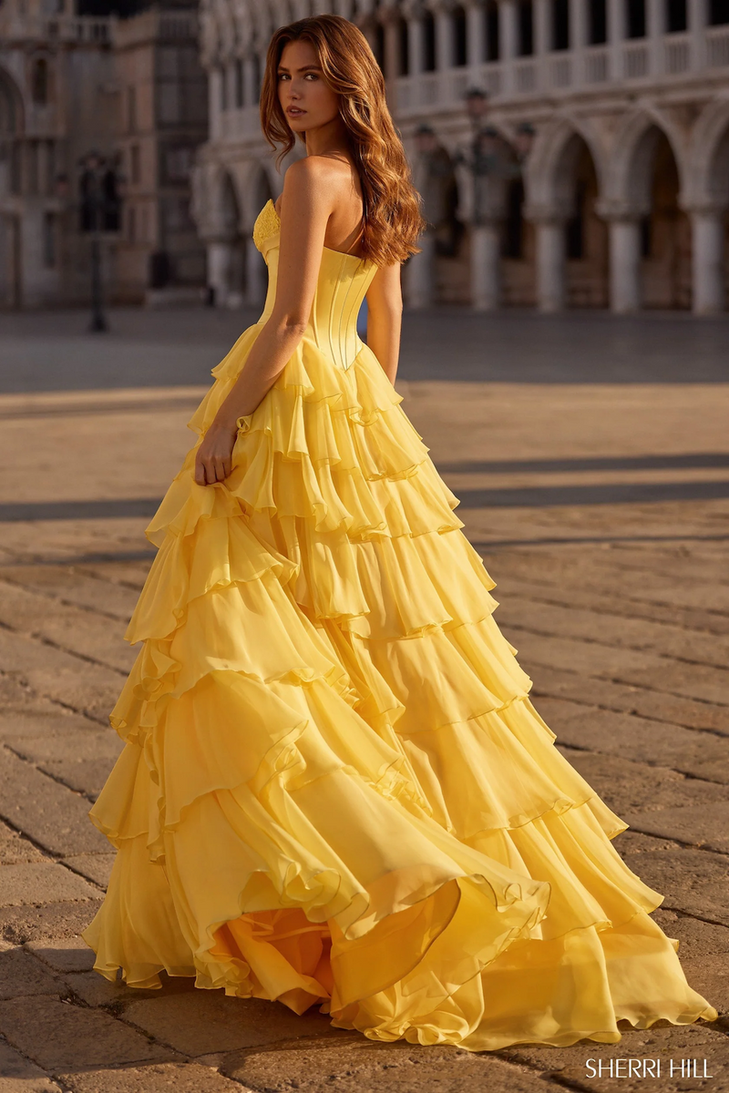 This strapless sweetheart ballgown features a silk corset bodice with a bow detail, a chiffon ruffle skirt, and a skirt slit. This dress is elegant and could be ideal for your next prom or formal event.

Sherri Hill 57586