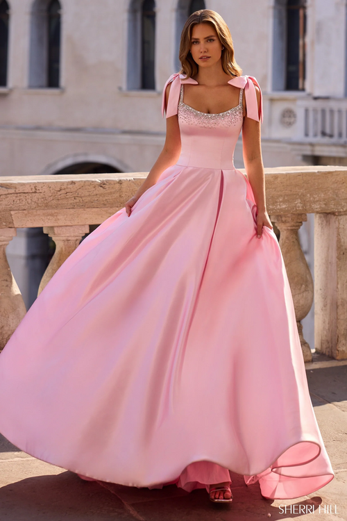 This ballgown features a drop waistline, straps with bows and bead embellishments along the neckline. Is this your dream prom dress?

Sherri Hill 57574
