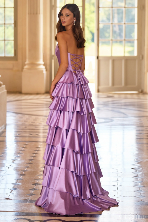 This dress features a strapless neckline with a corset bodice, a ruffle skirt with a slit in a satin fabric. This gown could be ideal for your next prom or formal event.

Sherri Hill 57686