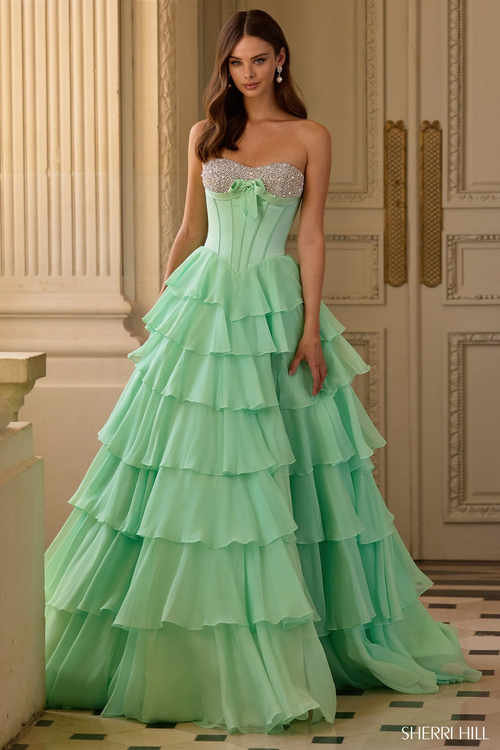 This dress features a strapless neckline with a corset bodice, pearl and bead embellishments, and a chiffon ruffle skirt with a slit. A stunning choice for your next prom or formal event.&nbsp;

Sherri Hill 57799