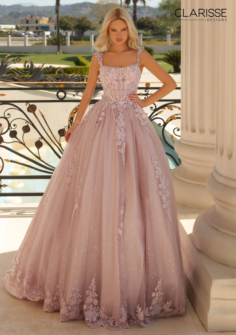 This glittery ballgown is adorned with a luxe lace applique and hot stones, and its sheer corset bodice and lace-up back will hug your figure while its pockets add a convenient design. Wear the straps off the shoulder or on the shoulder to create a versatile look at your next prom or formal event.  CLE 810888